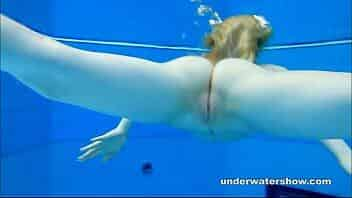 Cute Lucie is stripping underwater