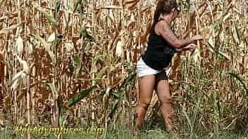 Chubby girl really needs to empty her bladder so she went into a corn field and pee with a big jet. PA211